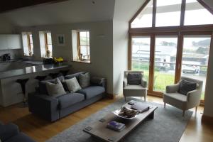 a living room with a couch and a table at Sandbar in Saint Just in Roseland