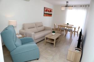 a living room with a couch and a table at Apartamentos La Botica de Nerja in Nerja