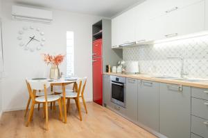 a kitchen with a table and chairs and a red refrigerator at The granny’s house in Kiaton