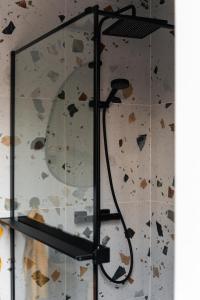 a glass shower in a room with a wall at Bérc Kabin Kismaros in Kismaros +57 photos