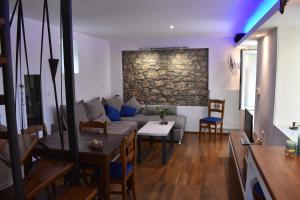 a living room with a couch and a table at Dolichi House in Pythagoreio