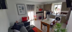 a small kitchen with a table and a small kitchen with a tableablish at Friendly Peniche Apartment in Peniche