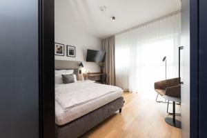 a bedroom with a bed and a mirror at Brera Serviced Apartments Singen in Singen