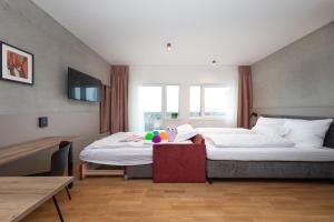 a hotel room with two beds and a table at Brera Serviced Apartments Singen in Singen