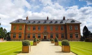 a large brick building with bushes in front of it at Queens Croft Abode in Newport