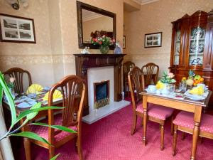 a dining room with a table and a fireplace at Number 10 Bed & Breakfast in Keswick