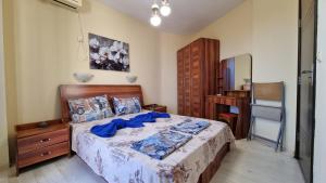 a bedroom with a bed with a dresser and a desk at Apartment Pool in Sinemorets