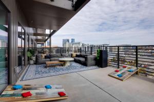 a balcony with couches and tables on a building at Nashville - 635 7th Ave S Unit 611 in Nashville