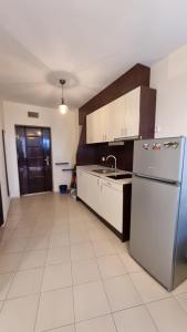 a kitchen with a sink and a refrigerator at Apartment Pool in Sinemorets