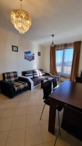 a large living room with a bed and a table at Apartment Pool in Sinemorets