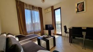 a living room with a couch and a table at Apartment Pool in Sinemorets