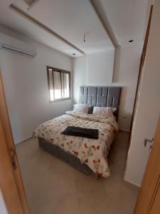 a bedroom with a large bed in a room at Stay downtown in Kenitra