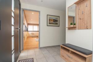 a hallway with a door leading to a living room at Le Pied à Terre de Montcenis - Appt avec parking privé in Montcenis +4 photos