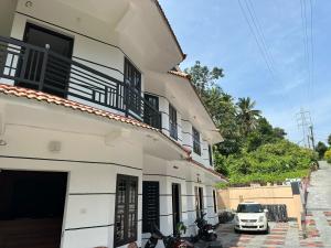 a building with motorcycles parked in front of it at Koshar Live in Kalpetta