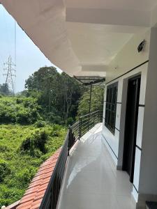 a balcony of a building with a view of a field at Koshar Live in Kalpetta