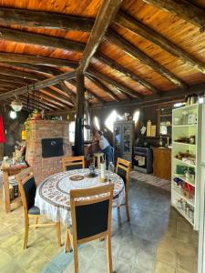 a dining room with a table and chairs and a kitchen at Bed and Breakfast near the Airport in Ezeiza