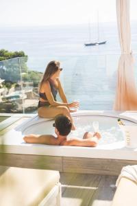 a man and a woman sitting in a bath tub at The Donna Portals in Portals Nous