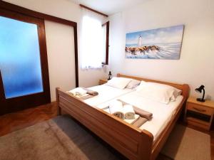 a bedroom with a bed and a large window at Apartments Miha in Krk