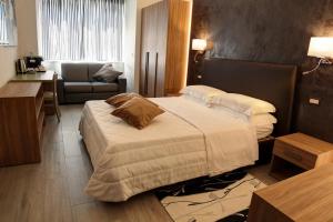 a hotel room with a large bed and a desk at Arsenale Turin Rooms in Turin