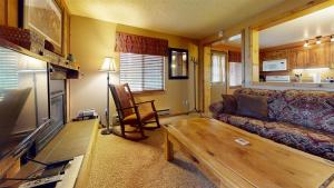 a living room with a couch and a table at Trapper Condo Unit 7 in West Yellowstone