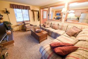 a living room with a couch and a table at Trapper Condo Unit 3 in West Yellowstone