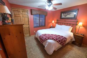 a bedroom with a bed and a ceiling fan at Trapper Condo Unit 3 in West Yellowstone