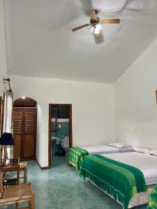 a bedroom with a bed and a ceiling fan at HOSTERIA EL PARAISO in Pedro Vicente Maldonado
