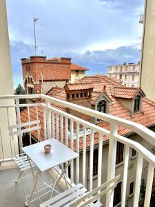 a balcony with a table and chairs on a building at La Casa Del Molo in Finale Ligure