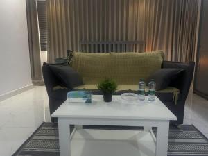 a living room with a couch and a table at Lovely Suite in Jeddah