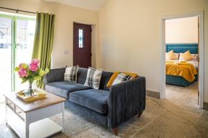 a living room with a couch and a bed at Bears Court in Cheltenham