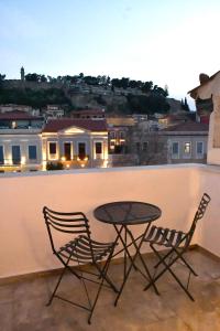 a table and two chairs sitting on a balcony at Porto Nafplio in Nafplio