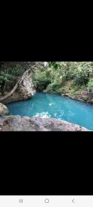 two pictures of a river with blue water at Kafi Studio in Liberia