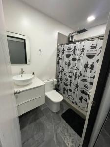 a bathroom with a toilet and a sink at Jaco Beach Villa Arenas Condo in Jacó