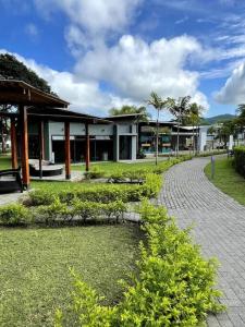 a building with a walkway in front of a building at Jaco Beach Villa Arenas Condo in Jacó