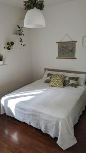 a bedroom with a bed with a white bedspread at Casa Reggiana in Reggio Emilia