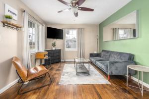 a living room with a couch and a table at Charm City Hideout 2bdr and Basement in Indianapolis