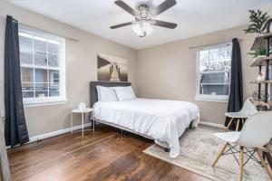 a bedroom with a bed and two windows at Charm City Hideout 2bdr and Basement in Indianapolis
