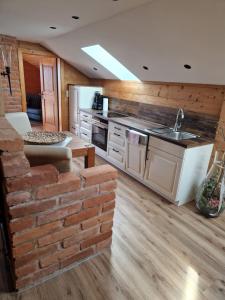 a kitchen with a brick wall and a sink at Plattenberger Hof in Waging am See