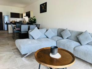 a living room with a couch and a table at Holiday apartment at La Diosa condos Isla Mujeres in Isla Mujeres