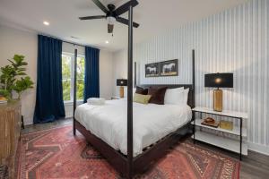 a bedroom with a large bed with a ceiling fan at Southern & Style-2 Townhomes-7 Mins To Broadway in Nashville