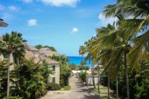 a street in front of a house with palm trees at Beacon Hill 304 by BSL Rentals in Saint Peter