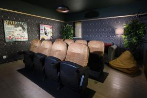 a waiting room with a bunch of chairs in a room at Cinema & Games Room Pool Table, Hot Tub, Sleeps 15 in Saffron Walden