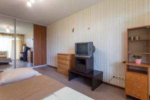 een slaapkamer met een bed en een tv op een standaard bij Apartment on 23 Serpnya in Charkov