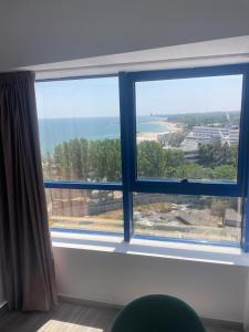 a large window with a view of the ocean at Sea View Apartments Olimp Etajul 9 in Olimp