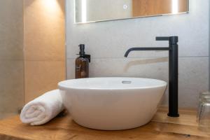 a bathroom with a bowl sink and a faucet at Hotel Krone Tirol in Reutte