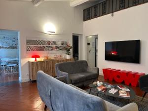 a living room with a couch and a tv at Uffizi Suite in Florence