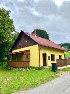 a small yellow house with a red roof at Jedlinka 37 in Klášterec nad Orlicí