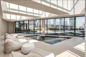 a living room with a couch and a swimming pool at Presidential Suite Heart of Downtown with Stunning View in Toronto