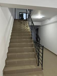 a staircase in a building with a black railing at Natymar in Adjud