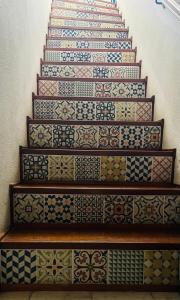 a staircase covered in differentially decorated tiles at Central Tavira apartment with balcony, Casa Cristina in Tavira